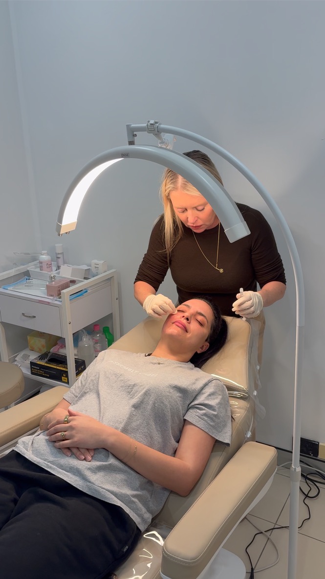 Natalie treating a client in the All Care Clinics treatment room